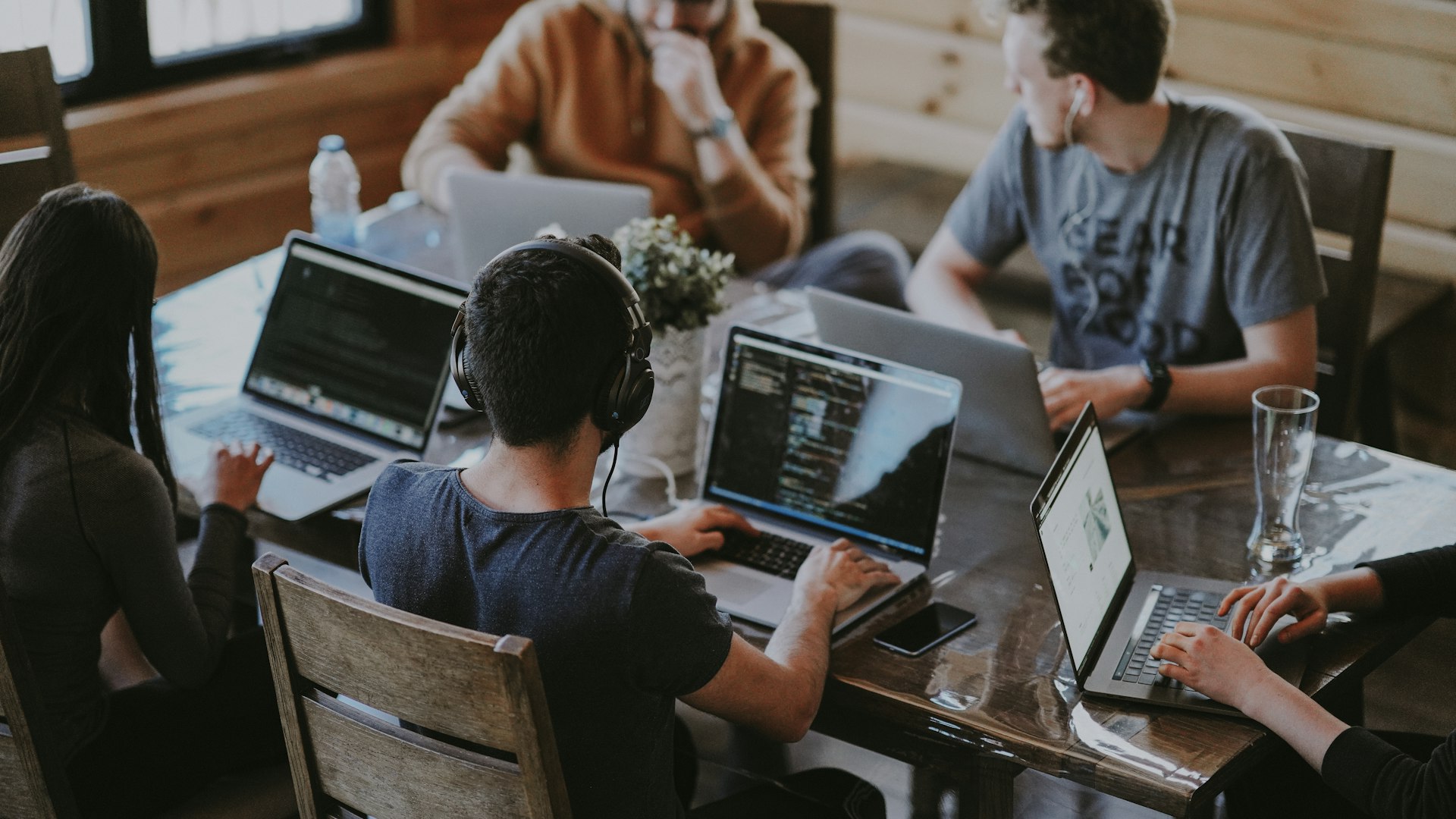 A remote team collaborating around a table in a bright workspace